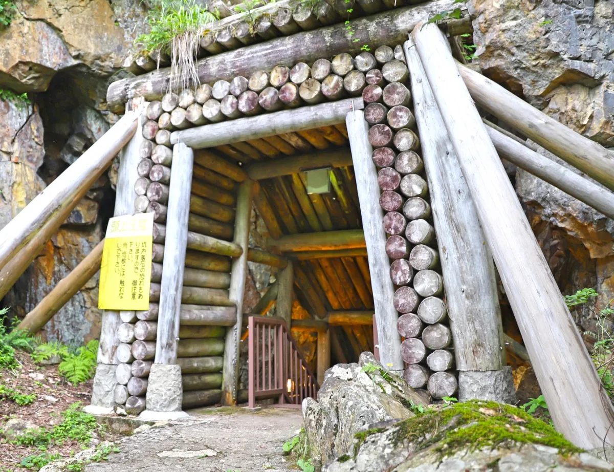 Log-framed entrance to the Nobesawa Silver Mine tunnel cut into rock