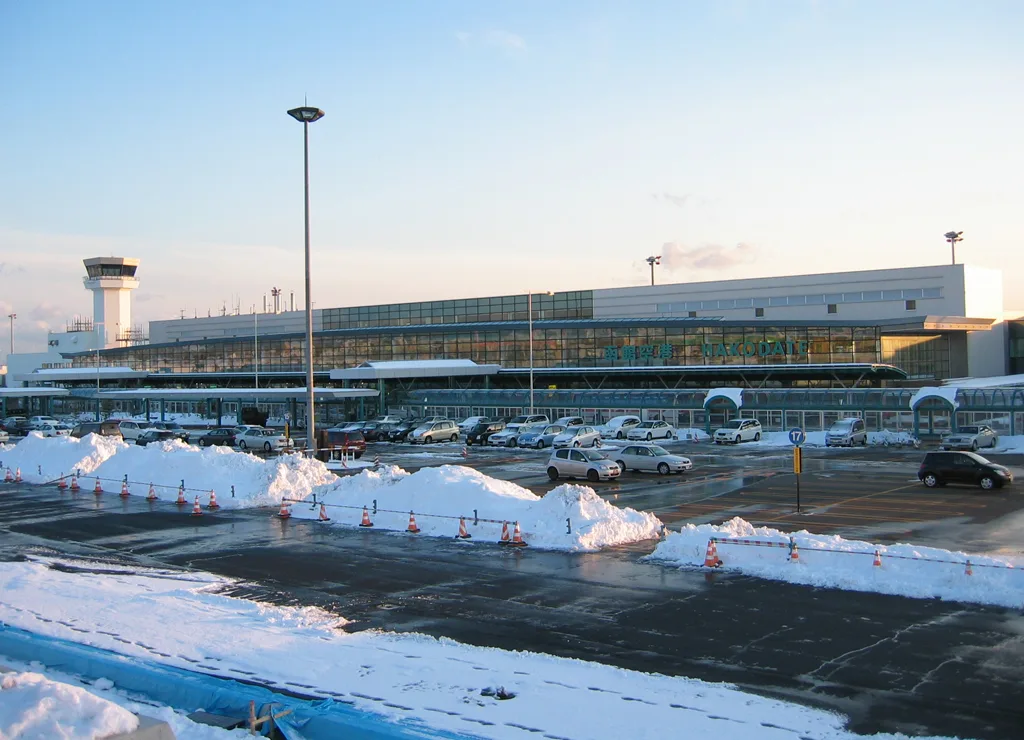 Hakodate Airport terminal building and control tower across a snowy car park