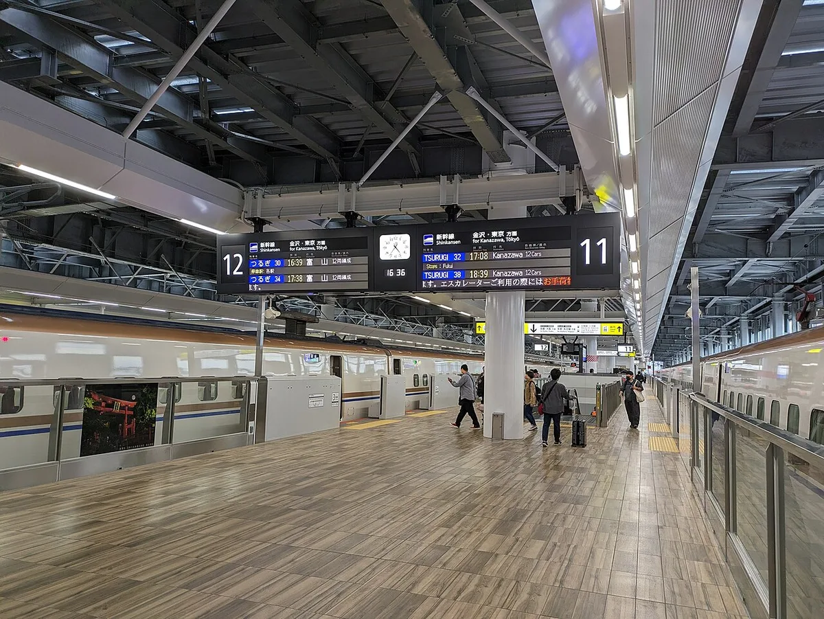 Hokuriku Shinkansen platform at Tsuruga Station with departure boards for Tsurugi trains to Kanazawa