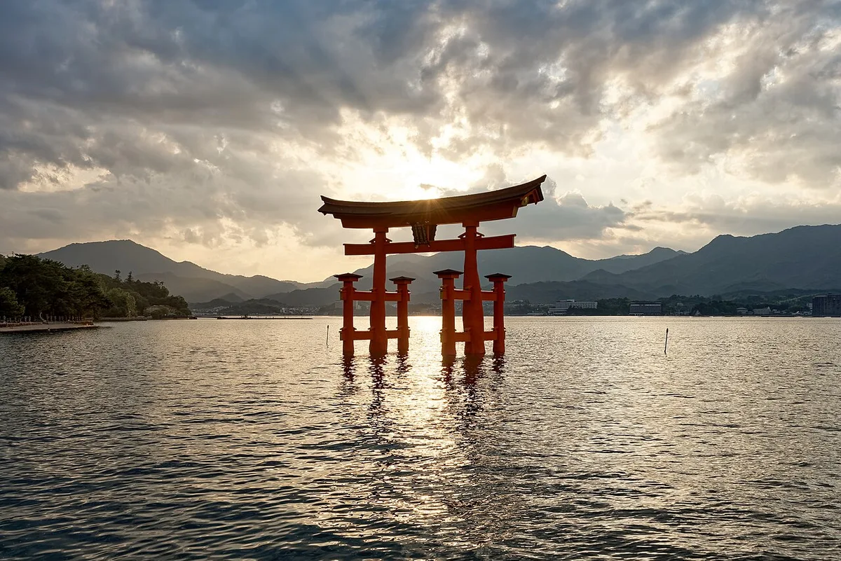 The Otorii gate of Itsukushima Shrine standing in the water at sunset, Miyajima