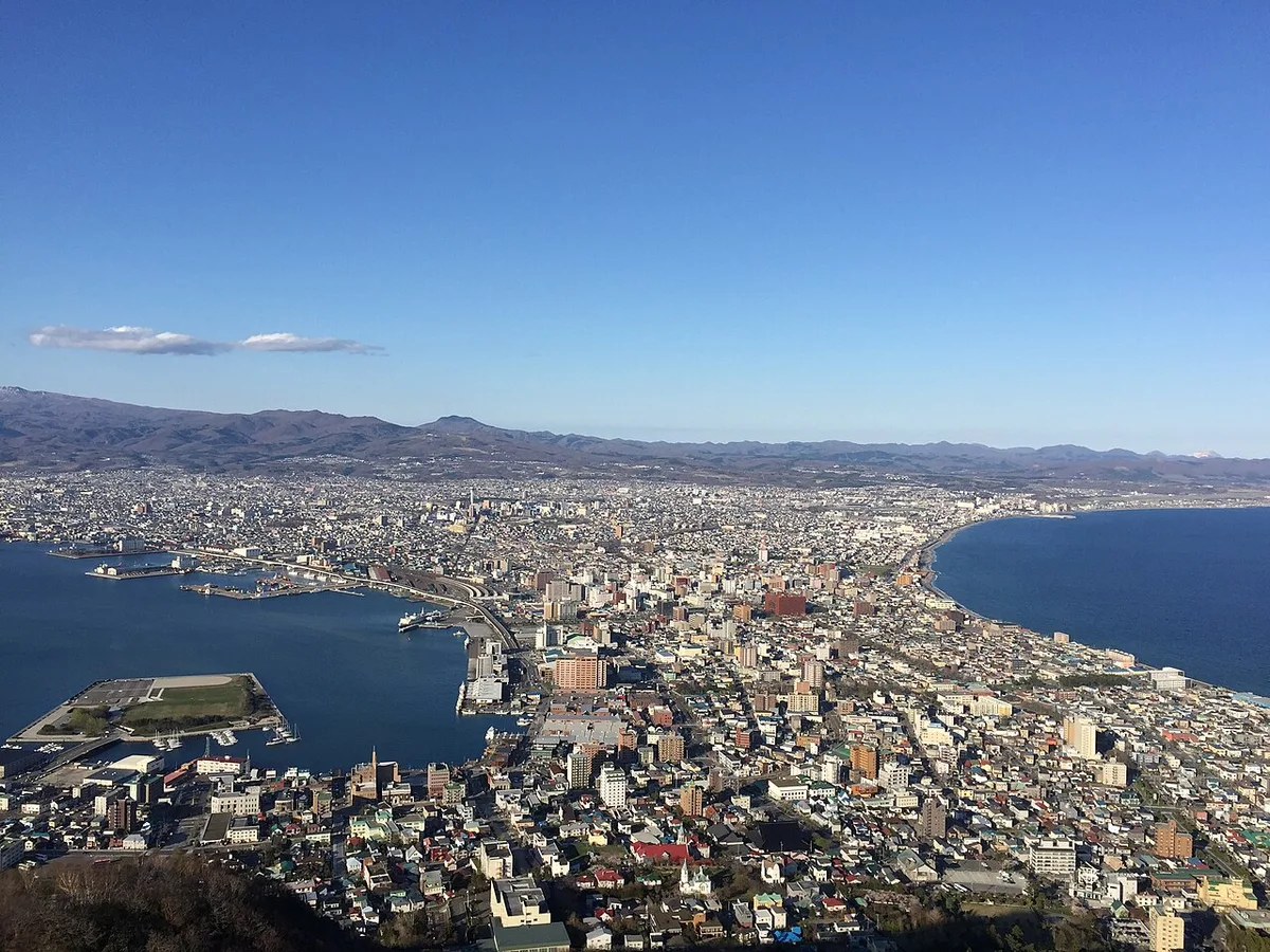 Hakodate seen from Mt. Hakodate by day, the city on a narrow neck of land between the harbour and the sea