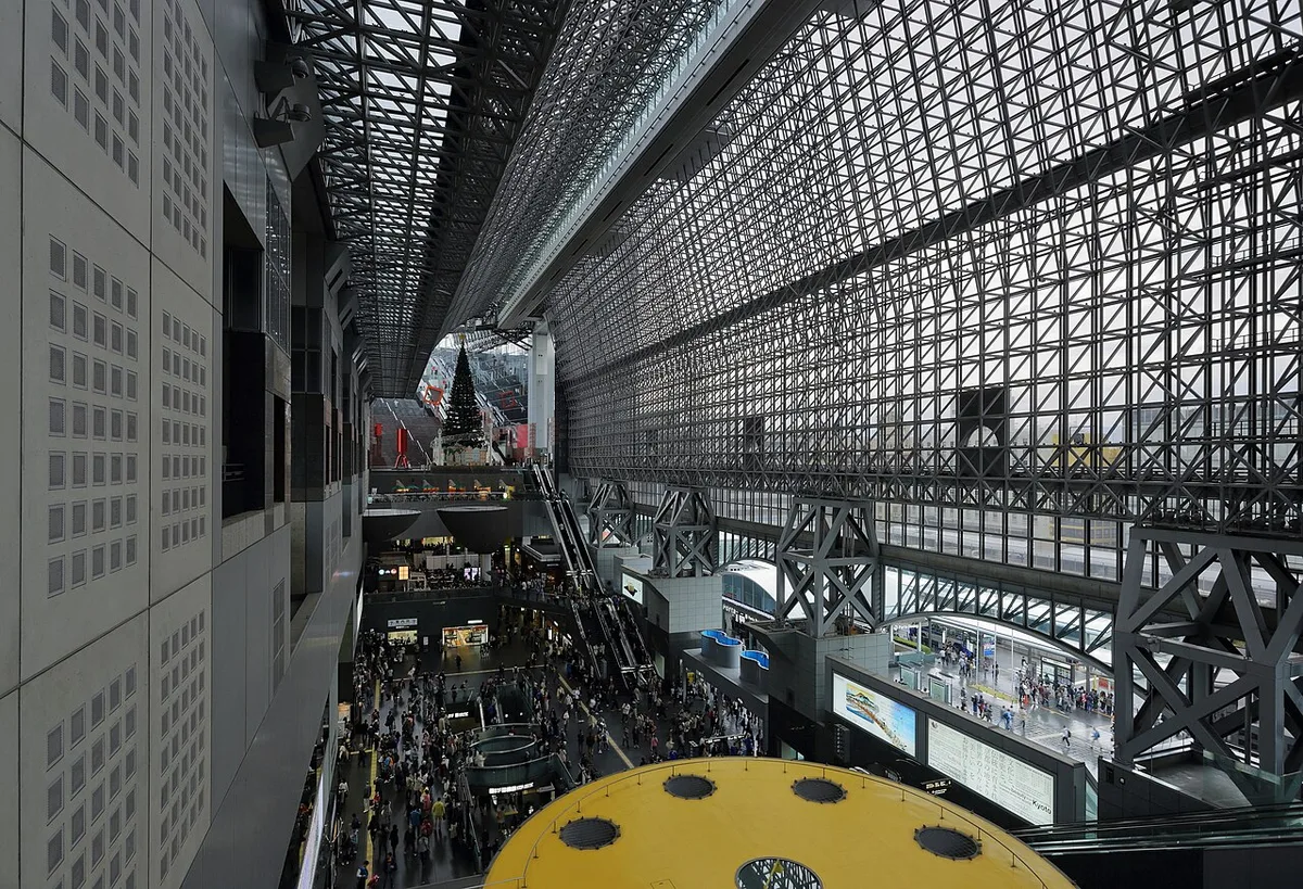 The glass-and-steel atrium of Kyoto Station, looking down on the central concourse and the grand staircase