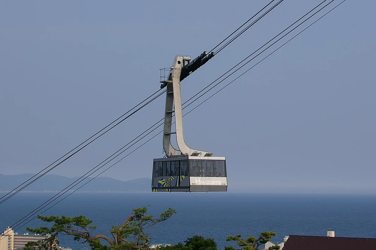 A Mt. Hakodate Ropeway gondola on its cables above the sea