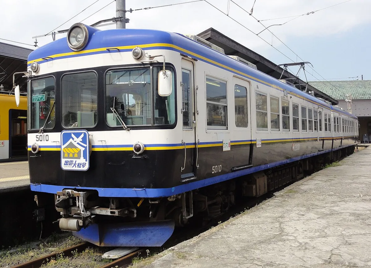 Blue and white Ichibata Railway train at a station platform
