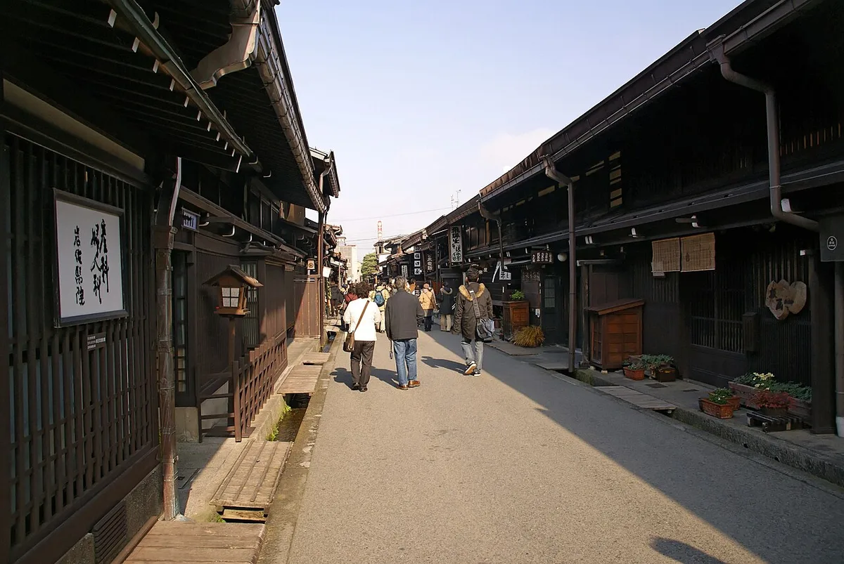 Dark wooden merchant houses lining a narrow street in Takayama's Sanmachi old town