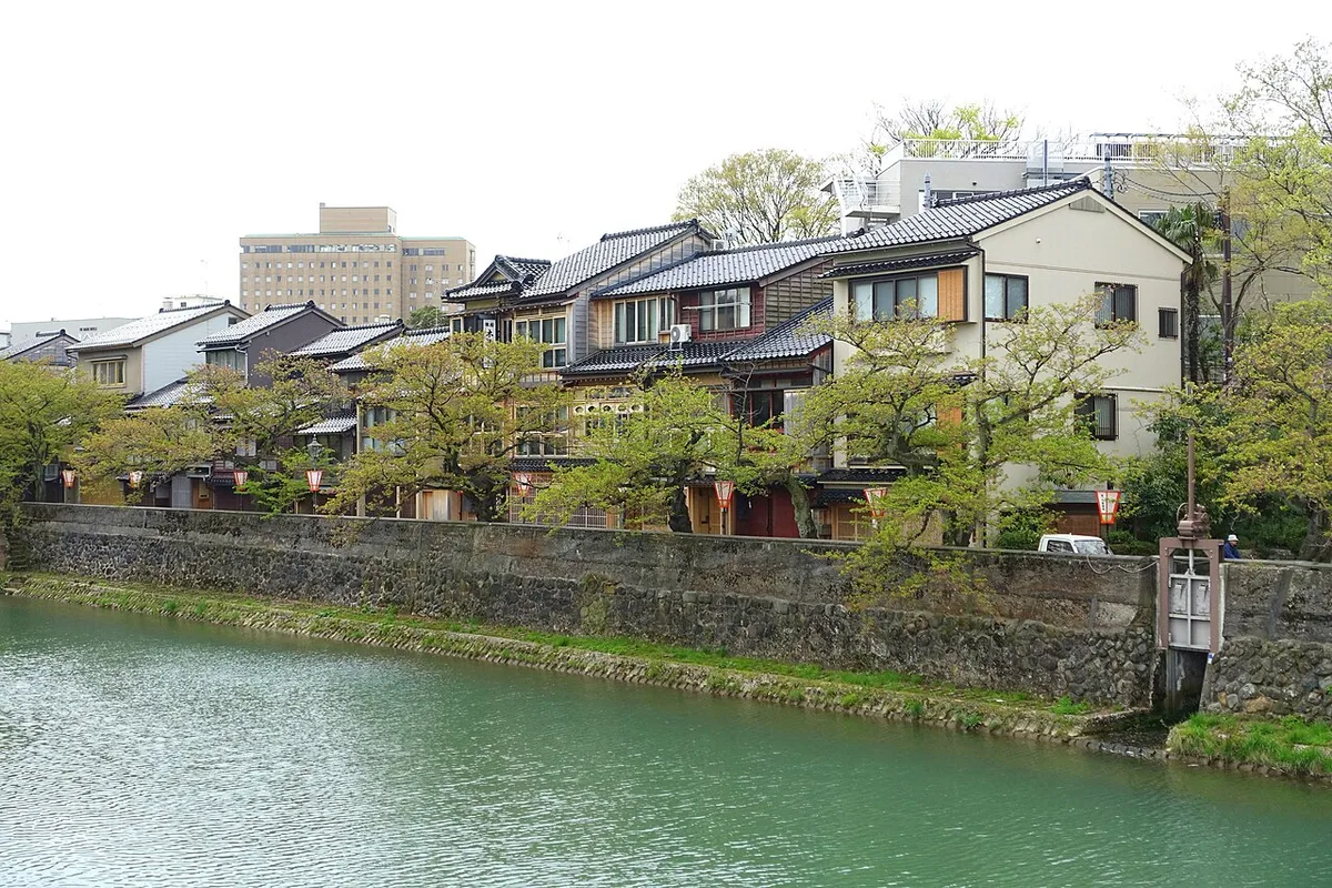Row of old wooden houses of Kazue-machi along the stone embankment of the Asano River